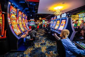 people sitting at the slot machines in a casino at Downtown Grand Hotel & Casino in Las Vegas
