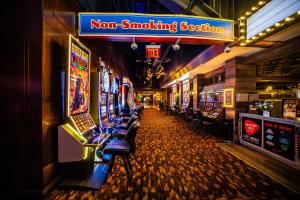 a room with many slot machines in a casino at Downtown Grand Hotel & Casino in Las Vegas