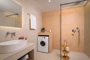 a bathroom with a sink and a washing machine at Pelagos Home in Kalamaki Heraklion +53 photos