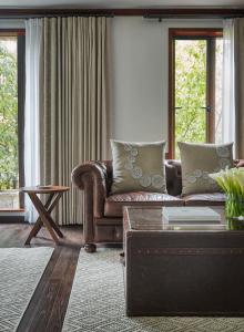 
a living room filled with furniture and a window at Four Seasons Hotel Casa Medina Bogota in Bogotá

