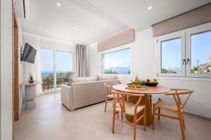 a living room with a couch and a table at Pelagos Home in Kalamaki Heraklion