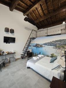 a bedroom with a large bed and a view of the water at Diana'S in Fiumefreddo di Sicilia