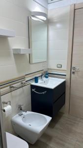 a bathroom with a white sink and a mirror at Copernico casa vacanze, nel centro di Lecce in Lecce +20 photos