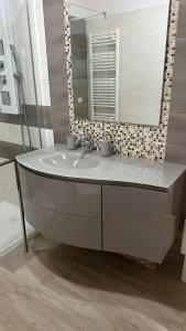 a bathroom with a sink and a mirror at Copernico casa vacanze, nel centro di Lecce in Lecce