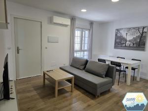 a living room with a couch and a table at Sunny Churriana Jacaranda III in Málaga