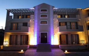 a large white building with lights on it at Niriides in Lefkada Town