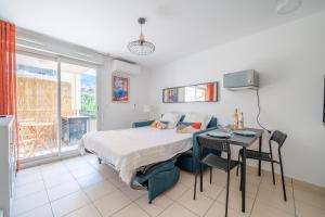 a bedroom with a bed and a table and a desk at Studio port de Nice Clim Balcon in Nice +6 photos