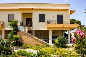 a house with a staircase in front of it at Casa Baí in Torre Nubia