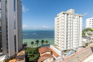 a view of the ocean from a building at Aptos completos na melhor localização e a passos do mar de Guarapari - STP in Guarapari