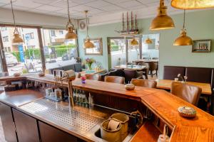 a bar in a restaurant with chairs and tables at Baltic Stuben Hotel Garni Travemünde in Lübeck