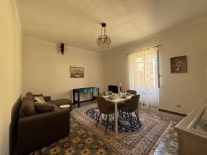 a living room with a couch and a table at Trilocale a 100 m dal mare in Imperia