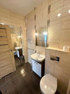 a bathroom with a white toilet and a sink at Willa Dominik 2 in Jastarnia +39 photos