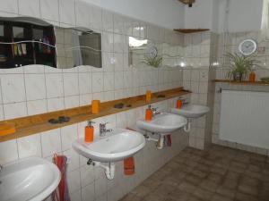 a bathroom with three sinks and two mirrors at Wochenend-Auszeit in Möckern +37 photos