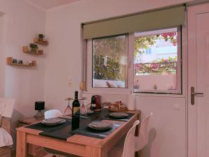 a kitchen with a table and a window and a table and chairs at Eleni studio apartment Preveza in Preveza