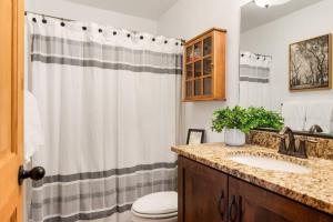 a bathroom with a shower curtain and a sink at Woodland Cabins by Jerny Destinations in Alton +43 photos