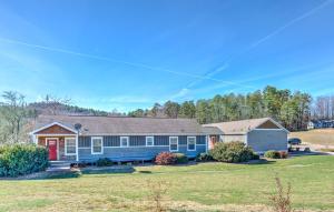 een blauw huis met een rode deur op een erf bij Travelers Fairview Haven in Fairview