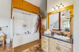 ein Badezimmer mit Badewanne, Dusche und Waschbecken in der Unterkunft Timberland in Garden City + 18 Fotos