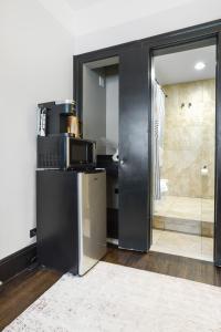 a microwave sitting on top of a refrigerator in a room at PH2 Studio At The Mansfield in New York