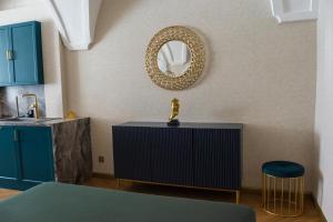 a bathroom with blue cabinets and a mirror on the wall at Luxury apartments Banská Bystrica on the main square- LUSSO, FRESCO, PURE in Banská Bystrica +117 photos