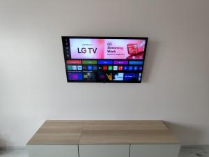 a flat screen tv hanging on a wall at J&N Hause in Visaginas