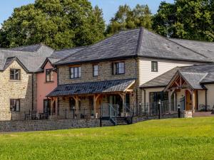 a large brick house with a black roof at 2 Bed in Usk 83993 in Trostrey