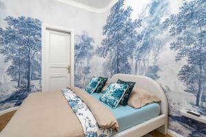 a bedroom with a bed with blue and white wallpaper at Riverside N22 in Prague