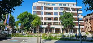 a tall white building on a city street at Ika Delux in Burgas