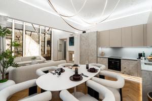 a dining room with a white table and chairs at Riverside N22 in Prague