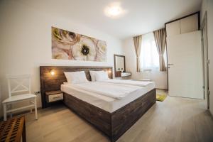 A bed or beds in a room at Apartments Harmonia