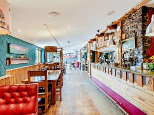 a restaurant with a table and chairs and a bar at 2 Bed in Westward Ho 41865 in Westward Ho +20 photos