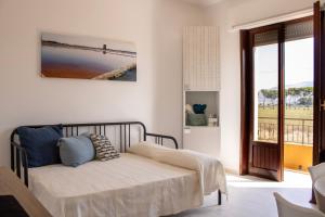 a bedroom with a bed with blue pillows on it at Casa Baí in Torre Nubia