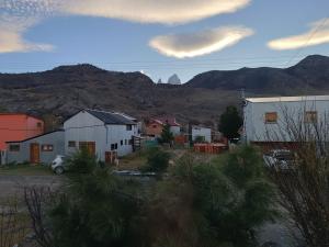 a small town with mountains in the background at El Kamaruco Tiny House in El Chalten