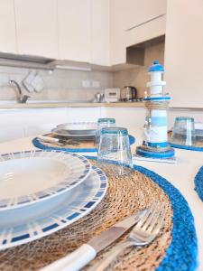 a table with plates and a lighthouse on it at Casa al Mare WiFi Ac in Chioggia