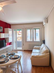 a living room with a couch and a table at Casa al Mare WiFi Ac in Chioggia