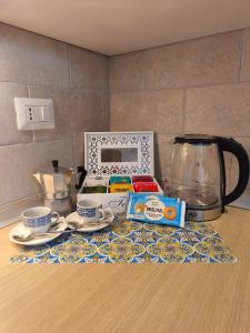 a table with cups and a tea set on a counter at Casa al Mare WiFi Ac in Chioggia