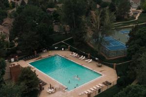 an overhead view of a swimming pool with people in it at Cozy Retreat - King Beds - Cinema Cave & Home Gym in Westminster