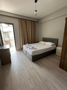 a bedroom with a bed and a large window at Viyana otel in Cesme
