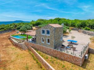 an aerial view of a stone house with a pool at Vila Mare in Risika