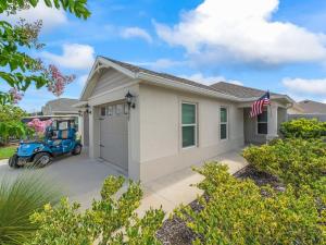 a blue truck parked in front of a house at 5537 Z6 HAMMOCK AT FENNEY by REMAX PREMIER REALTY in The Villages