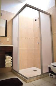 a shower with a glass door in a bathroom at House equipped with two bedrooms in La Paz +9 photos