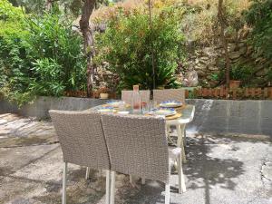 a table with two chairs and a table with plates on it at La Huerta del Parral in Soportújar