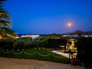 a view of a backyard at night with a house at "Kouremenos Beach" seaside Apartments in Palekastron
