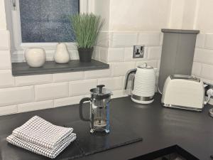 a kitchen counter with a blender on a counter top at Abbey Cottage in Llangollen