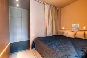 En eller flere senge i et værelse på Parkview Residence Bliss