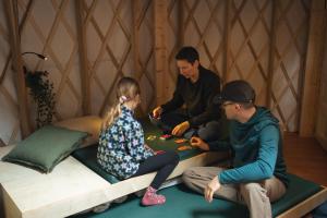 a group of people playing a game in a igloo at Spacious Yurt in the Woods in Sainte-Agathe-des-Monts +35 photos