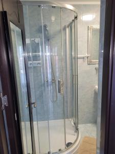 a shower with a glass door in a bathroom at Kys House in Techirghiol +85 photos