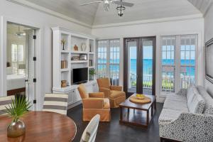 a living room with a couch and a table at French Leave Resort, Autograph Collection in Governorʼs Harbour