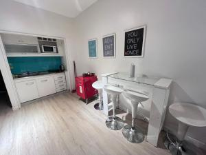 a kitchen with a table and stools in a room at Apart Fede in Buenos Aires
