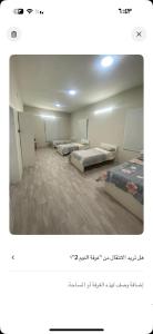 a room with several beds in it with aebinebinebin at فيلا مطله in Muqammar