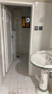 a white bathroom with a sink and a shower at فيلا مطله in Muqammar +25 photos